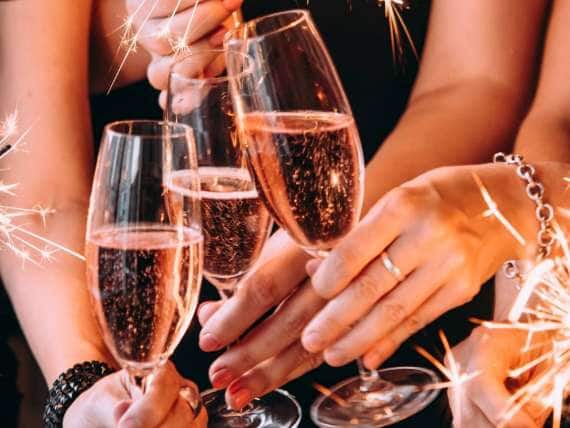Champagne toast among friends with sparklers. Celebrate your holiday on an all-inclusive, luxury Seabourn cruise.