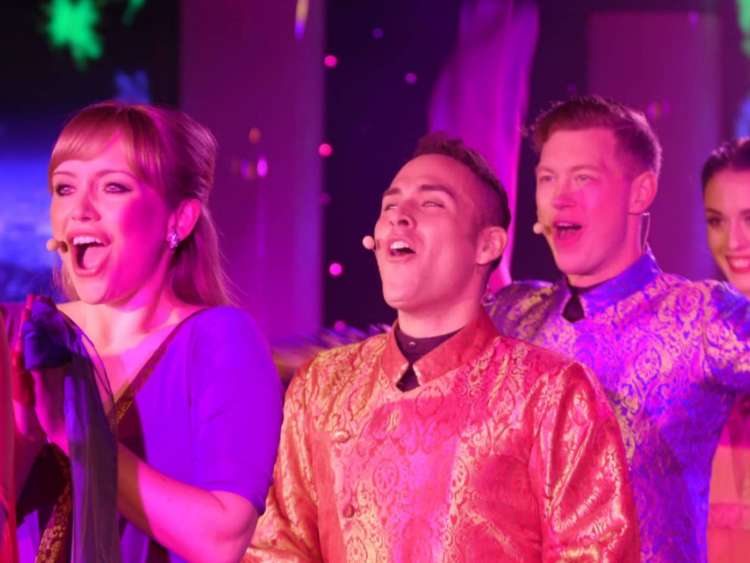 Vocal performance group sings in the Grand Salon on an all-inclusive, luxury Seabourn cruise.
