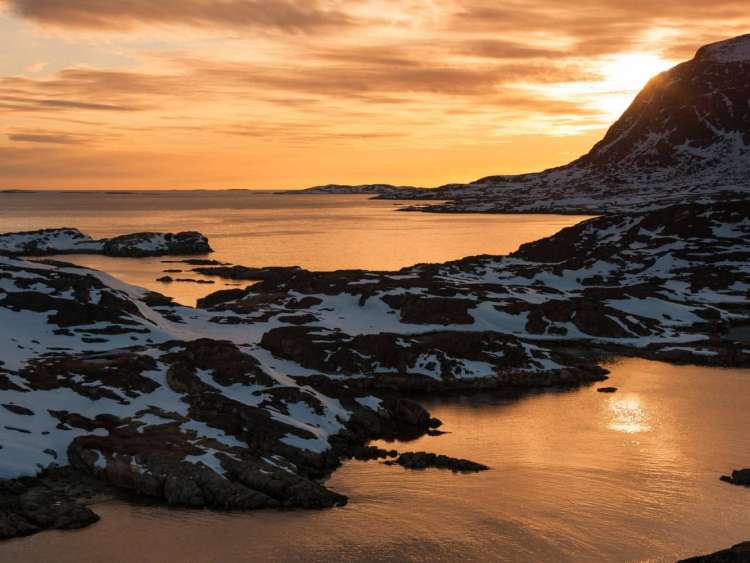 Sunset at Sisimiut near Amerloq Fjord, Greenland, an area visited on an all-inclusive, luxury expedition Seabourn cruise.