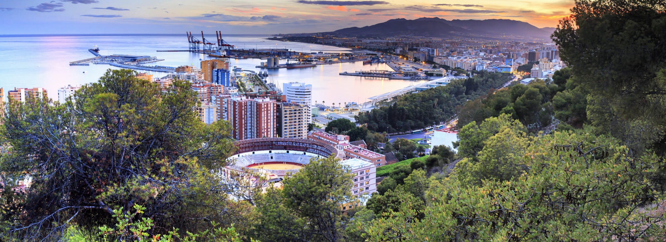 Spain, Andalusia, Malaga district, Malaga, Cityscape with the famous bullring at sunset, view from Monte de Gibralfaro