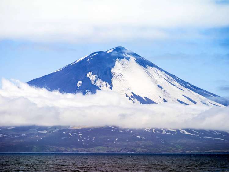 Alaid volcano on Atlasova Island, Russia, a port visited on an all-inclusive, luxury expedition Seabourn cruise.