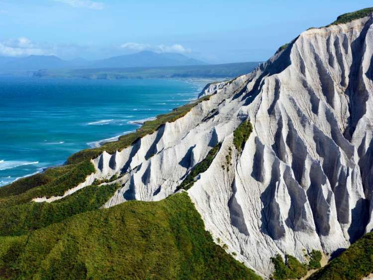 White cliffs of Iturup Island, Russia, a port visited on an all-inclusive, luxury expedition Seabourn cruise.