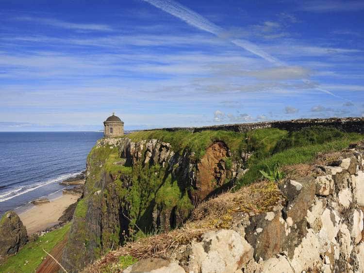 UK, Northern Ireland, Derry, View of the Mussenden Temple and Bishop's Palace, part of the Downhill Estate, perched on a cliff top near Coleraine.