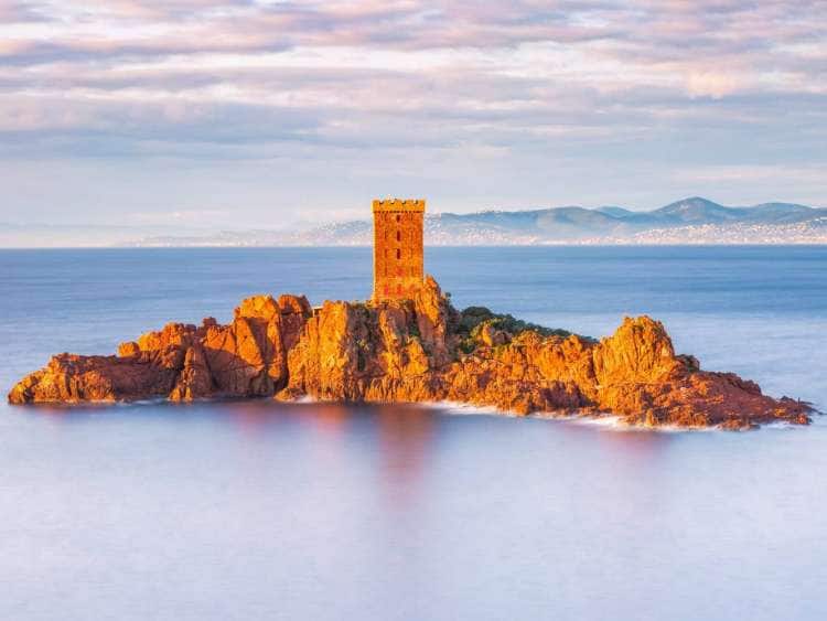 The small, rocky island of Ile d’Or and its medieval tower seen from Saint-Raphaël, France, one of many ports visited on an all-inclusive, luxury Seabourn cruise.