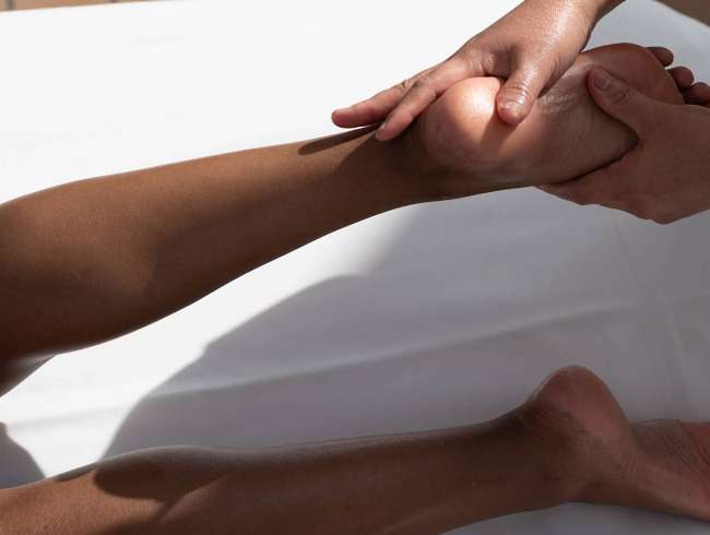 Woman receiving a massage while on an all-inclusive, luxury Seabourn cruise.
