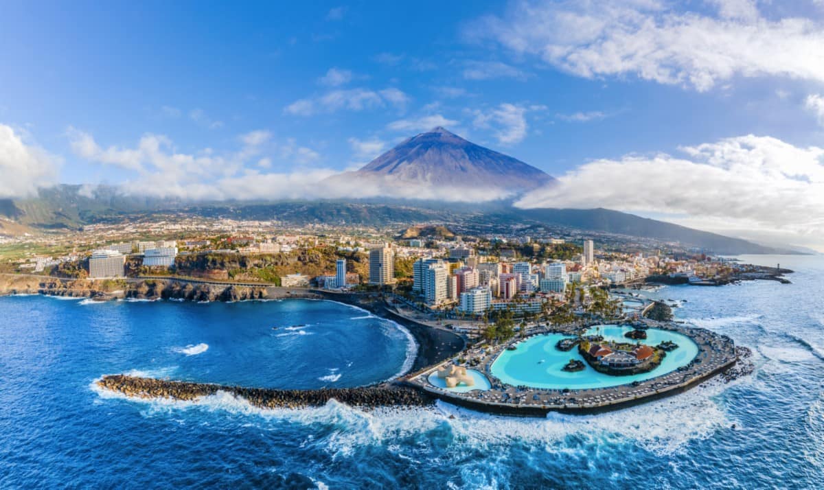 Aerial view of Puerto de la Cruz with Teide volcano in background, Tenerife island, Spain.