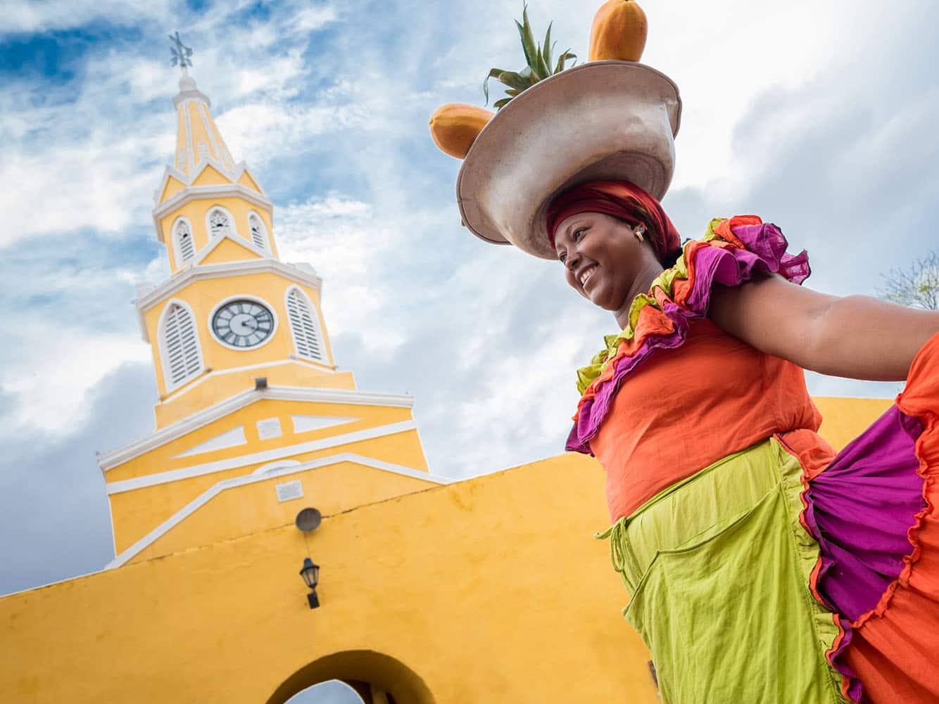 Happy Palenquera selling fruits in Cartagena