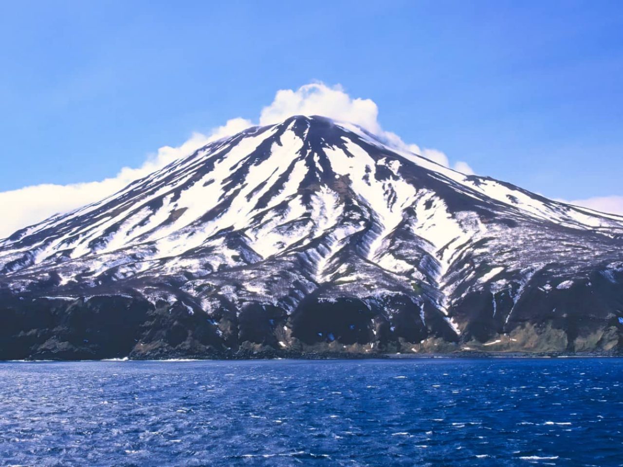 View of a stratovolcano on Simushir Island, Russia, a port visited on an all-inclusive, luxury expedition Seabourn cruise. 