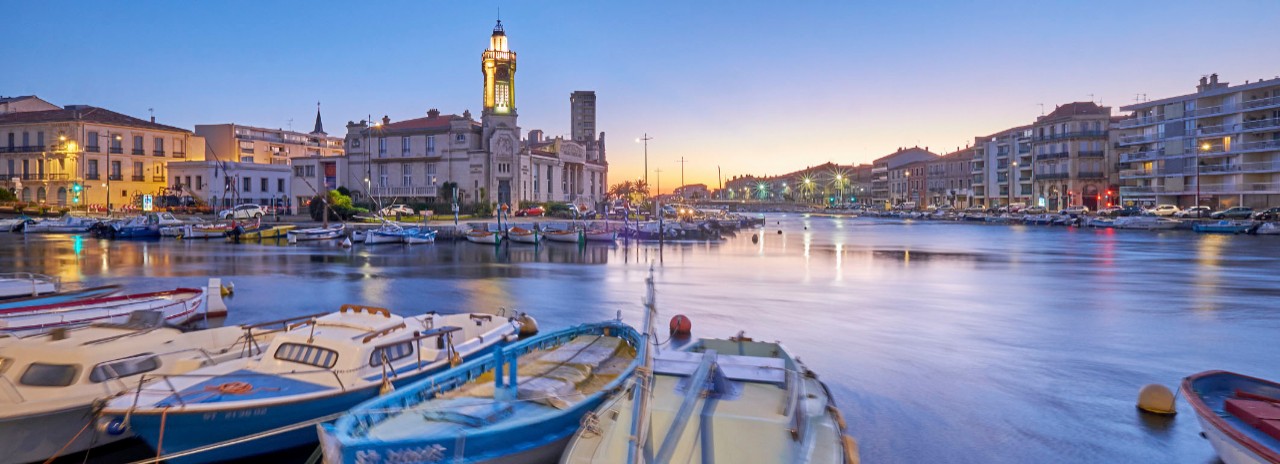 France, Occitanie, Sete, Herault, The Canal de Sete and the Canal de la Peyrade with the Palais Consulaire in background at dawn