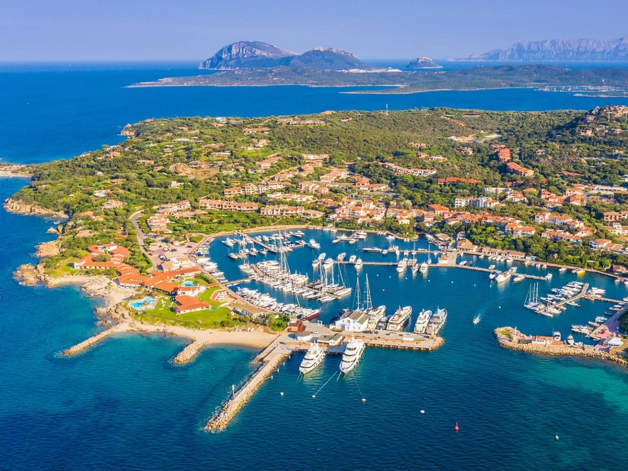  Aerial view Golfo Aranci, a port visited on an all-inclusive, luxury Seabourn cruise. 