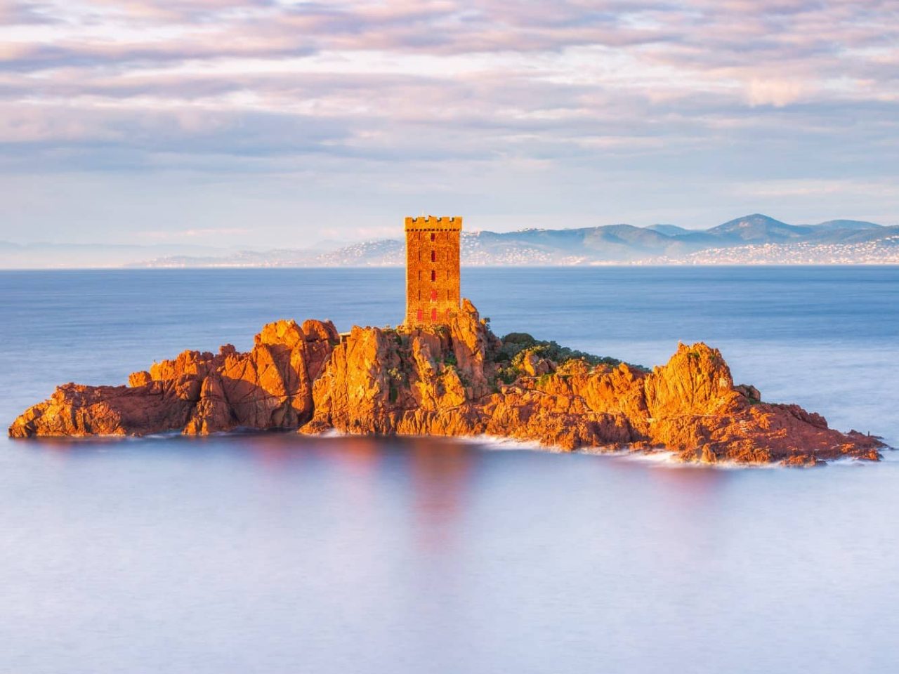 The small, rocky island of Ile d’Or and its medieval tower seen from Saint-Raphaël, France, one of many ports visited on an all-inclusive, luxury Seabourn cruise. 
