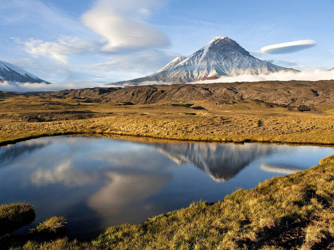 Klyuchevskaya Sopka stratovolcano reflected in pond and seen in background on Kamchatka Peninsula, Russia, an area visited on an all-inclusive, luxury expedition Seabourn cruise. 