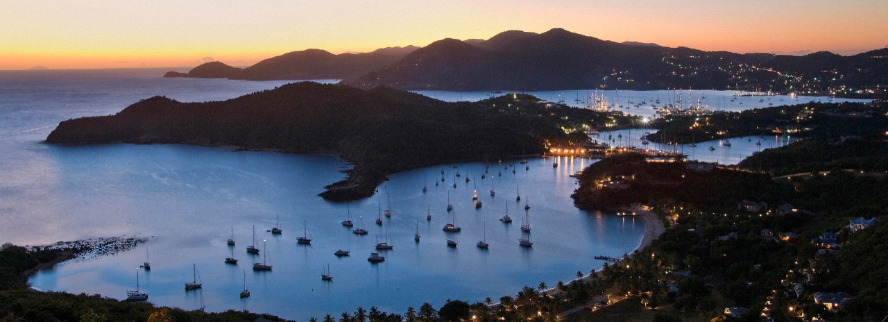 Caribbean, Antigua and Barbuda, Antigua, Shirley Heights, panoramic view towards English Harbor and Falmouth Harbor at dusk