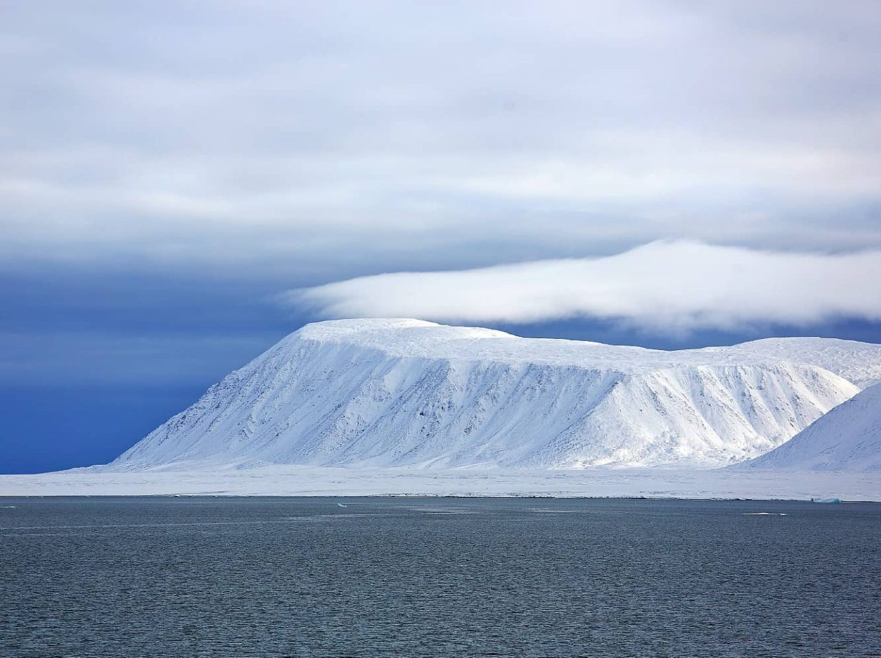 Frozen, mountainous shoreline of Bolshevik Island, a port visited on an all-inclusive, luxury expedition Seabourn cruise. 