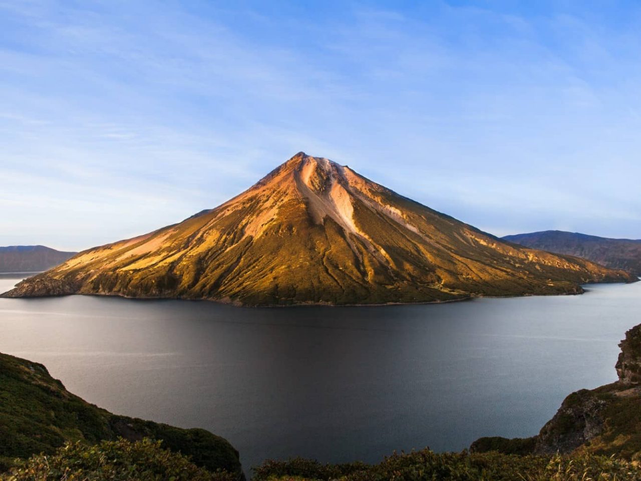 Krenitsyn volcano and crater lake on Onekotan Island, Russia, a port visited on an all-inclusive, luxury expedition Seabourn cruise. 