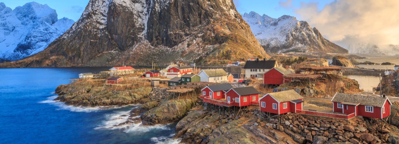 Hamnoy fishing village with red rorbu houses in Norwegian fjord in winter. Lofoten Islands, Norway. Seabourn Northern Europe Experience