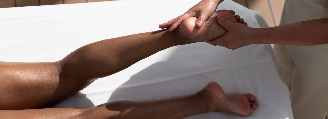 Woman receiving a massage while on an all-inclusive, luxury Seabourn cruise. 