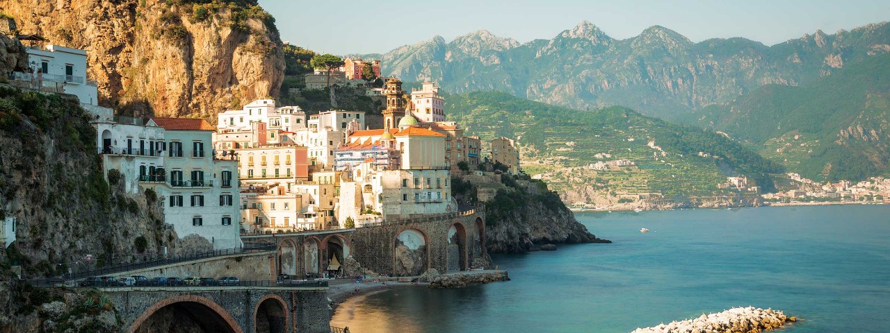 Neutral colored buildings next to the coast in the Amalfi Coast, Italy
