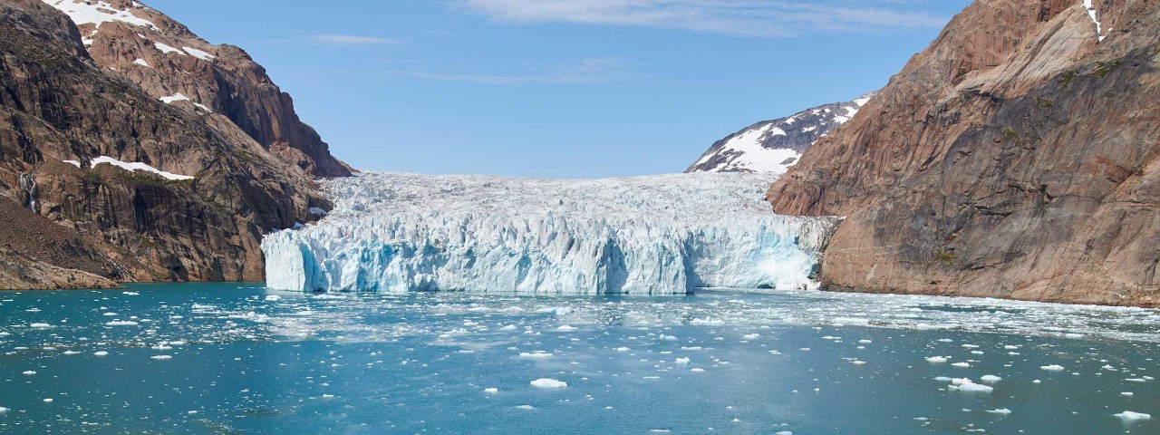 white and blue glacier in the water in Greenland